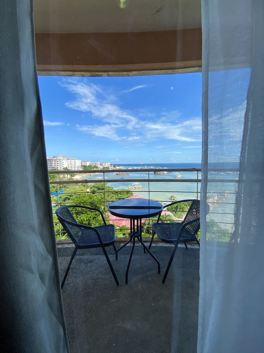 シービューの部屋のカーテン越しに見えるバルコニーと海